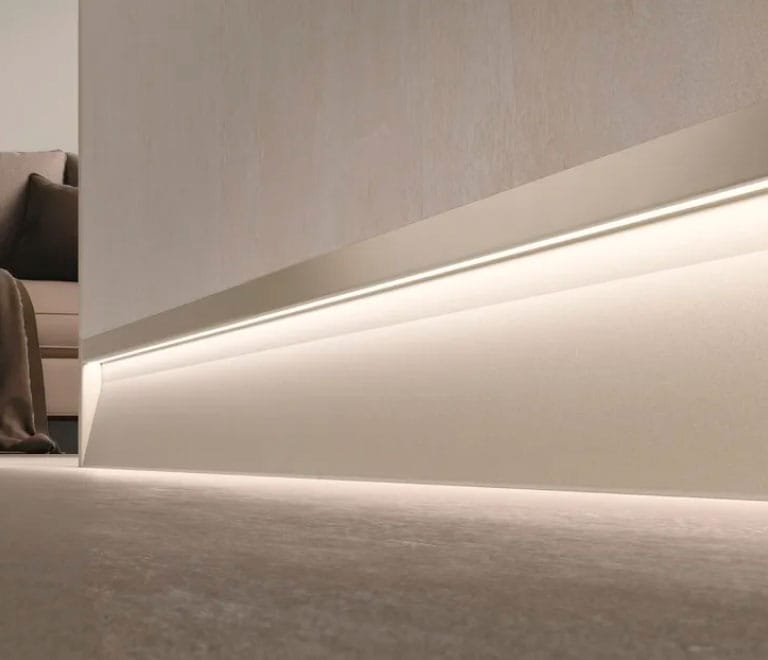 Baseboard lighting installed along a room's floor trim